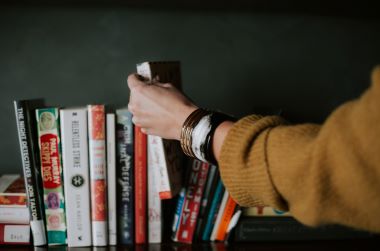 Woman reaching for CBD book