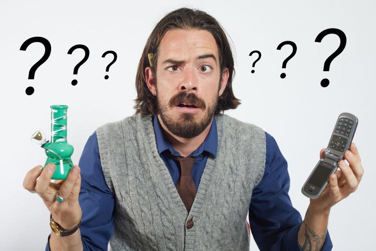 A guy holding a small green water pipe and a cellphone, questioning look on his face and question marks on the sides