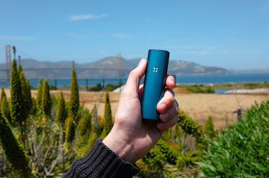 Man holding Pax 3 vape